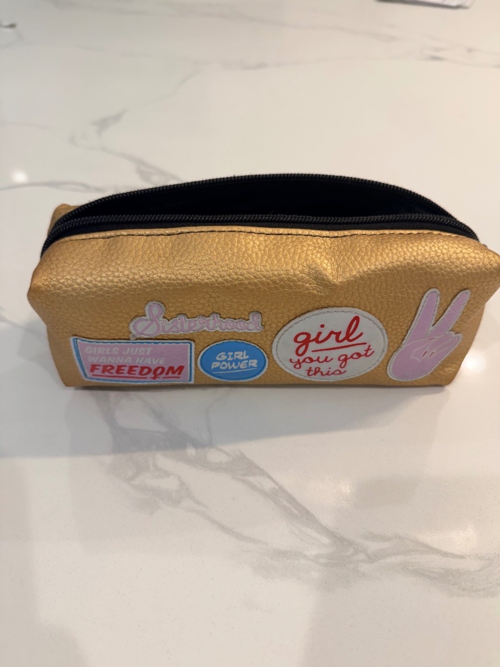 gold faux-leather cosmetic or pencil pouch